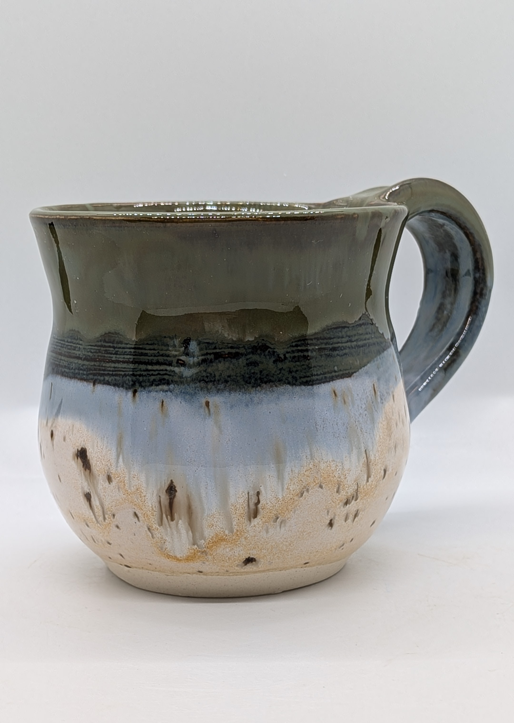 Green-Blue Mug - This beauty was a new glaze combo for me, and I love how it turned out. If you're a fan of lake-like blues and greens, you'll love this nature-inspired piece, which is complemented by birch-bark-like coloring on the bottom half. 

Holds about 8 fl. oz. - 30